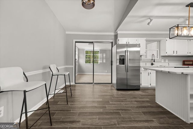 kitchen with white cabinetry, stainless steel fridge with ice dispenser, dark hardwood / wood-style flooring, and decorative light fixtures