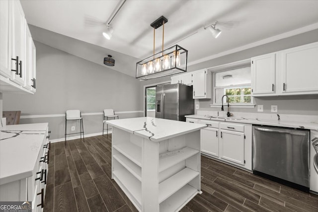 kitchen featuring white cabinets, a healthy amount of sunlight, sink, and appliances with stainless steel finishes