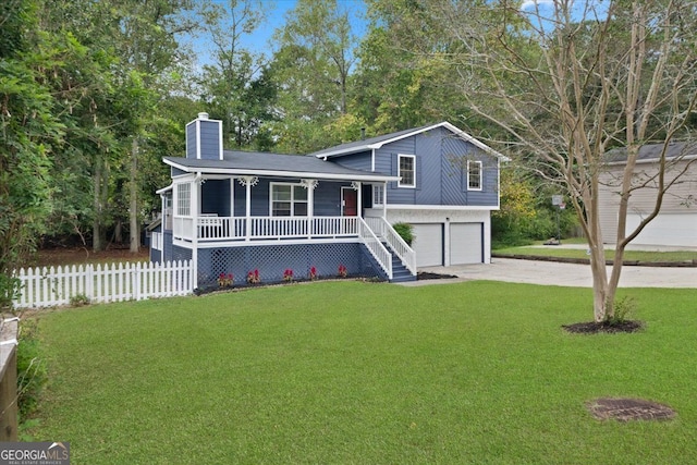 split level home with a porch, a garage, and a front yard