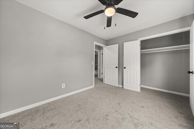 unfurnished bedroom with carpet, a closet, and ceiling fan