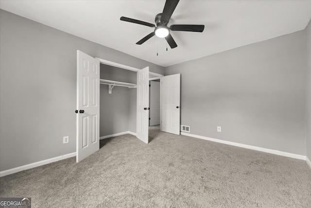 unfurnished bedroom featuring carpet flooring, a closet, and ceiling fan