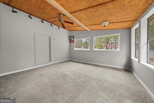 carpeted empty room with vaulted ceiling, ceiling fan, and wood ceiling