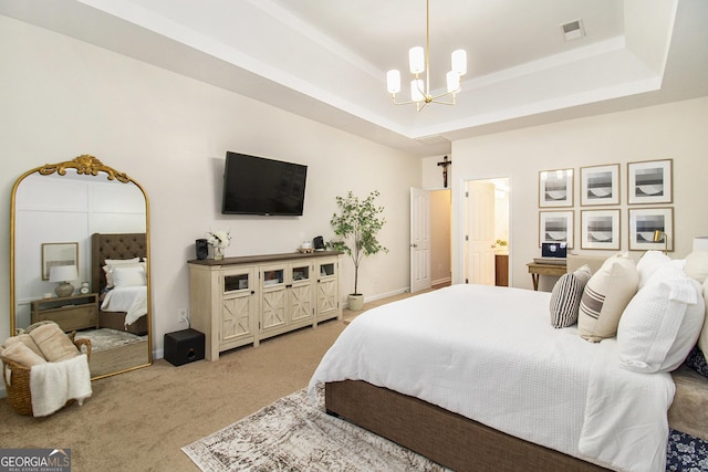 bedroom with a raised ceiling, carpet floors, and a notable chandelier