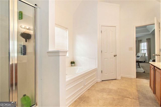 full bath featuring a garden tub, a closet, a stall shower, and vanity