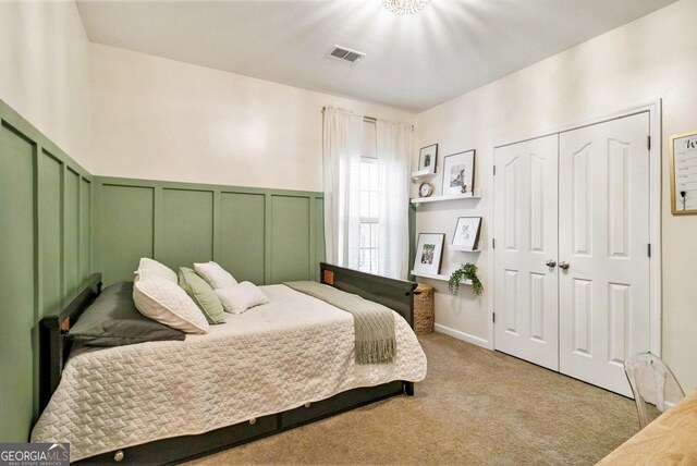 carpeted bedroom featuring two closets