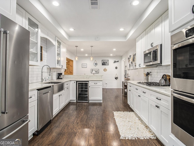 kitchen with white cabinetry, sink, beverage cooler, stainless steel appliances, and dark hardwood / wood-style flooring