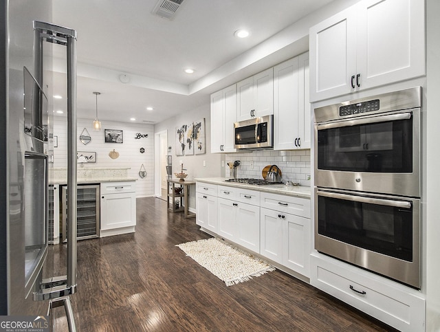 kitchen featuring white cabinetry, stainless steel appliances, tasteful backsplash, wine cooler, and pendant lighting