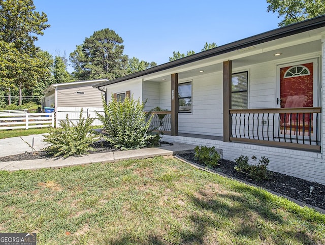 ranch-style home with a porch and a front yard