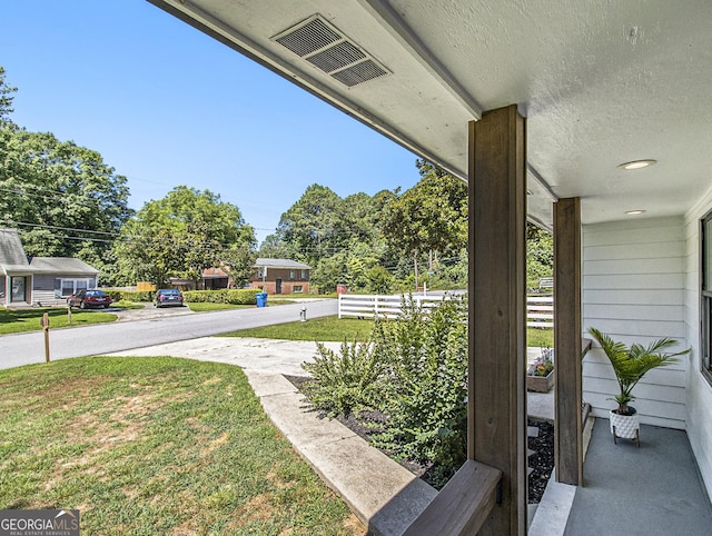 view of yard with covered porch