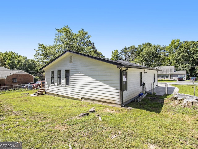 view of home's exterior with a yard