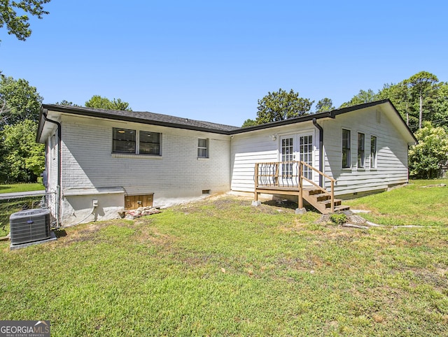 rear view of house featuring french doors, a yard, and central AC unit