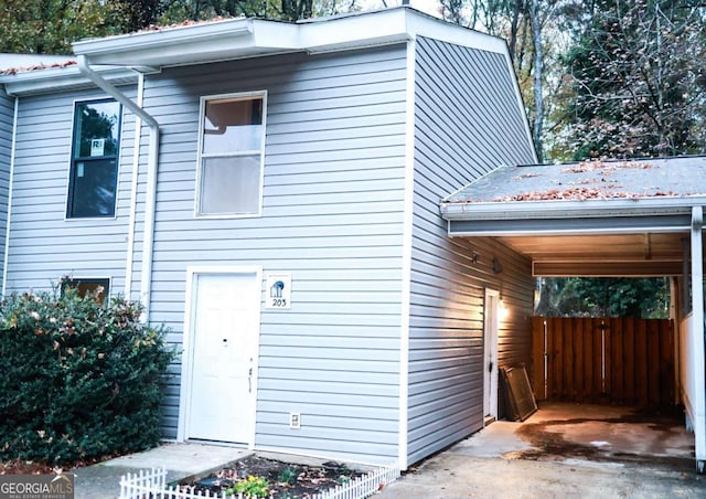 view of property exterior featuring a carport