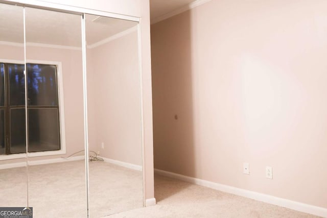 unfurnished room featuring carpet floors and crown molding