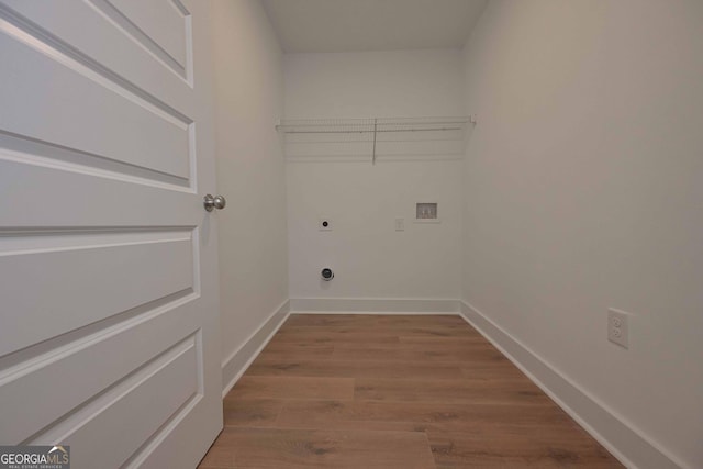 clothes washing area with laundry area, washer hookup, wood finished floors, baseboards, and electric dryer hookup