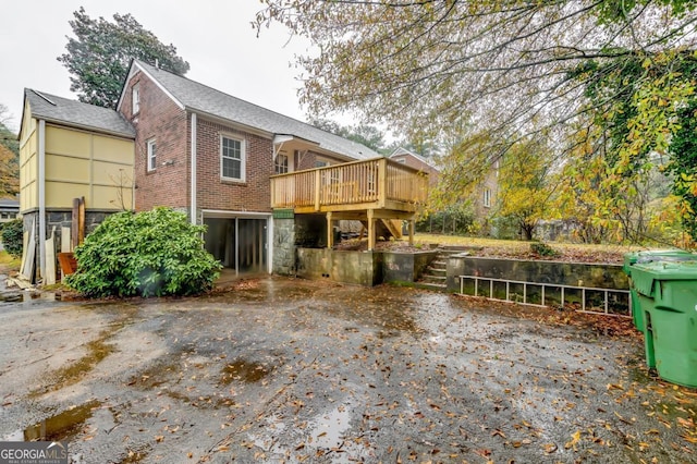 back of property with a wooden deck