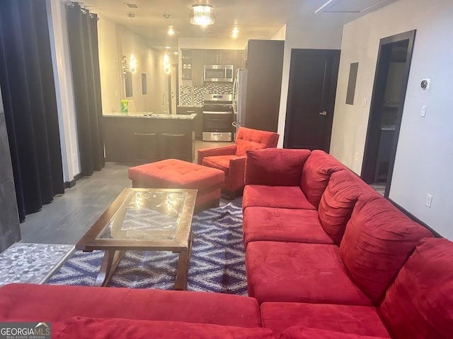 living room featuring hardwood / wood-style floors and sink