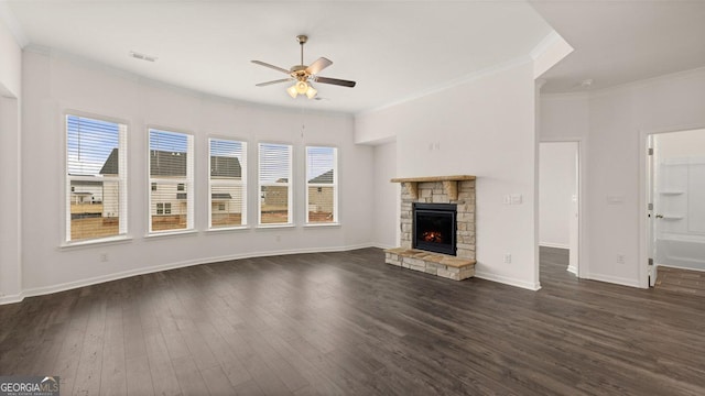 unfurnished living room featuring a stone fireplace, ceiling fan, dark hardwood / wood-style flooring, and ornamental molding