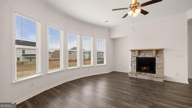 unfurnished living room with crown molding, a fireplace, ceiling fan, and dark wood-type flooring