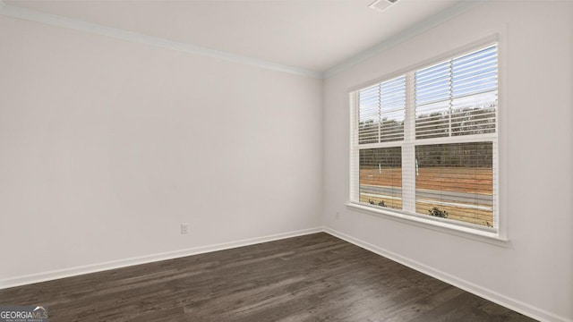 empty room featuring crown molding and dark wood-type flooring