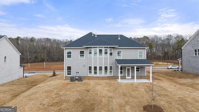 rear view of house featuring a patio area and central AC