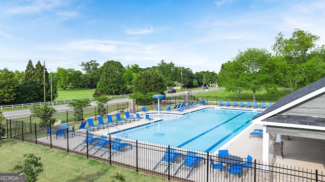 view of swimming pool with a patio area and a yard