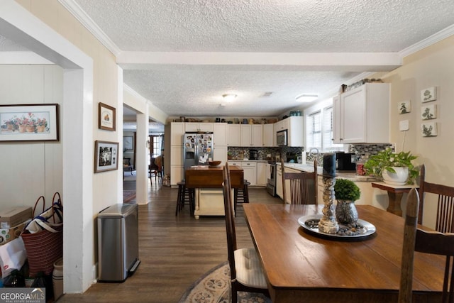 dining space featuring a textured ceiling, crown molding, and dark wood-type flooring