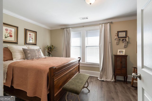 bedroom with dark hardwood / wood-style floors and ornamental molding