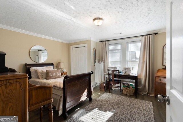 bedroom featuring a closet, crown molding, dark hardwood / wood-style flooring, and a textured ceiling