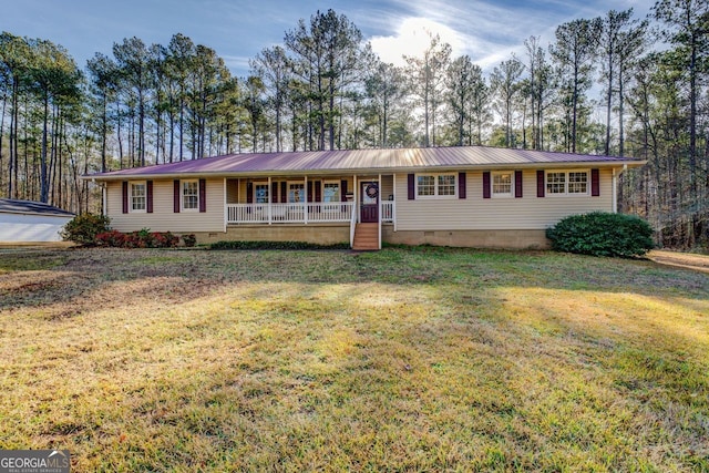 ranch-style home with covered porch and a front lawn