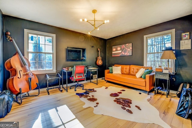 living room featuring hardwood / wood-style flooring and an inviting chandelier