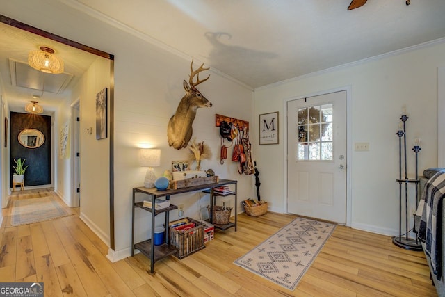 foyer entrance featuring ornamental molding and light wood-type flooring