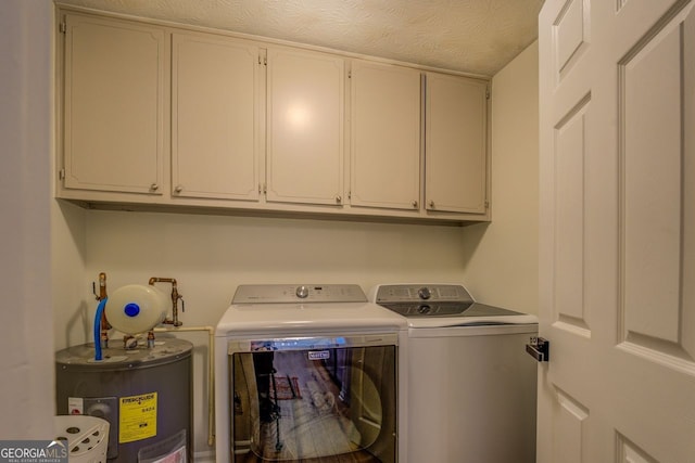 laundry room with independent washer and dryer, cabinets, electric water heater, and a textured ceiling