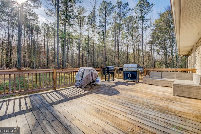 wooden terrace with grilling area and outdoor lounge area