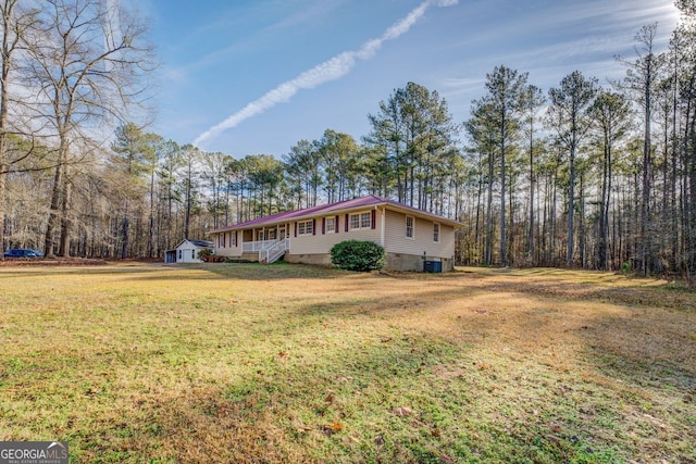 view of side of property featuring a yard and central AC unit