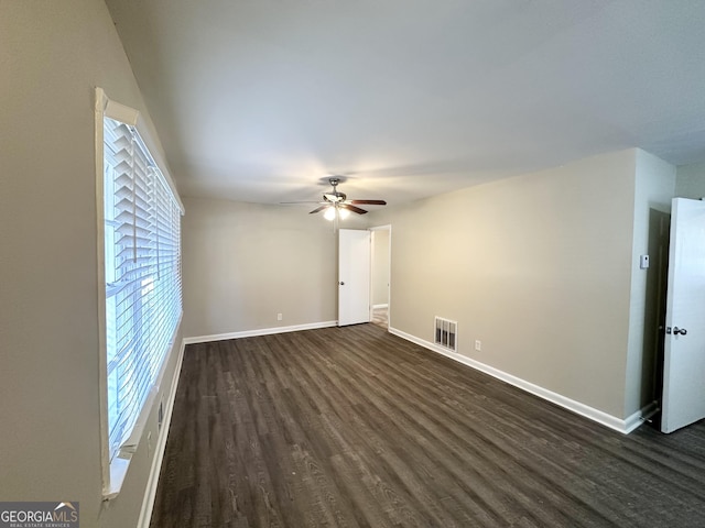 empty room featuring dark hardwood / wood-style flooring and ceiling fan