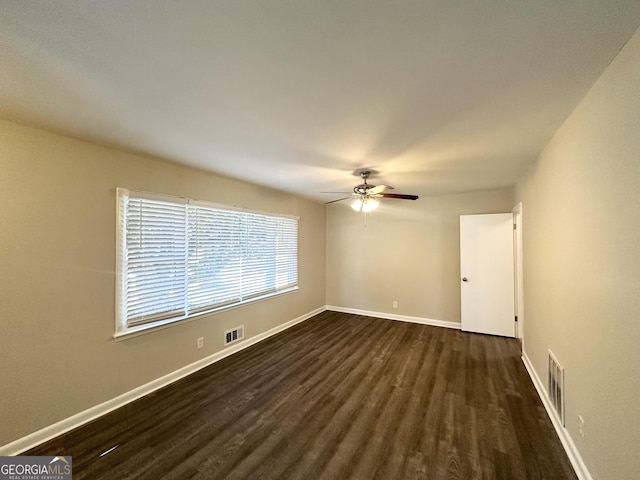 spare room featuring ceiling fan and dark hardwood / wood-style flooring