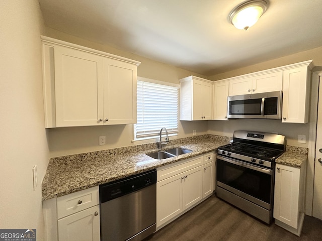 kitchen with white cabinets, stainless steel appliances, and sink