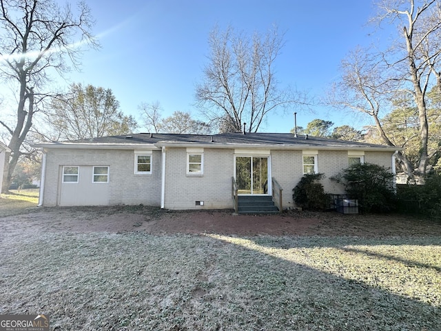 rear view of house with a yard