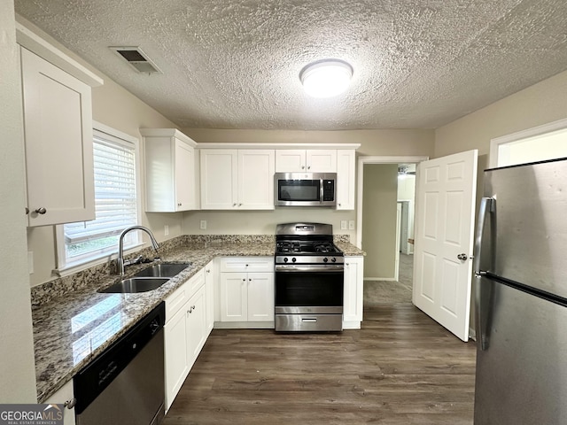 kitchen featuring white cabinets, dark hardwood / wood-style floors, sink, and stainless steel appliances