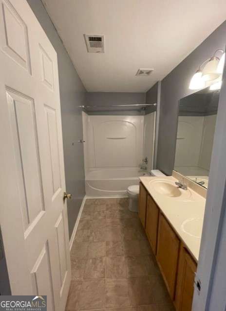 full bathroom with shower / washtub combination, vanity, and toilet