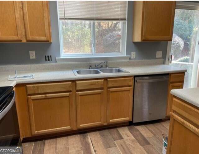 kitchen with dishwasher, light hardwood / wood-style floors, and sink