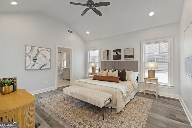 bedroom with lofted ceiling, ceiling fan, dark wood-type flooring, and connected bathroom