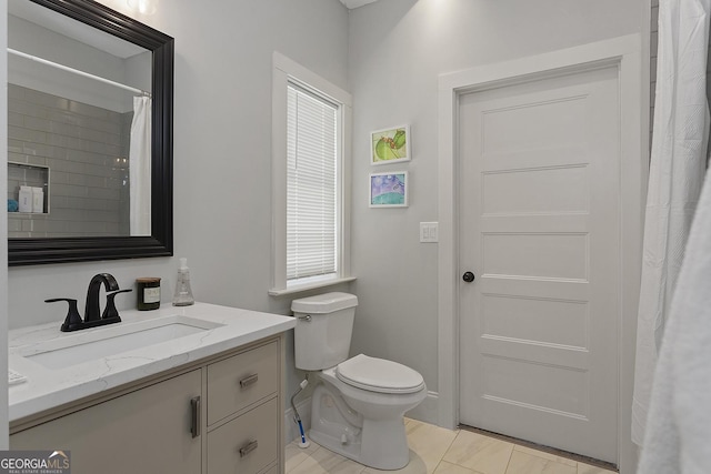 bathroom with tile patterned flooring, vanity, toilet, and a shower with curtain