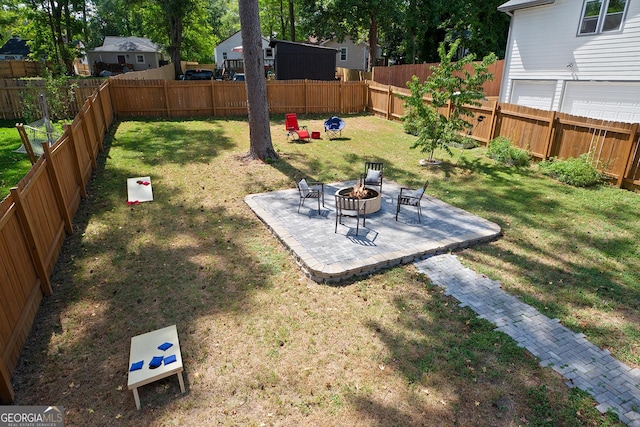 view of yard with an outdoor fire pit and a patio