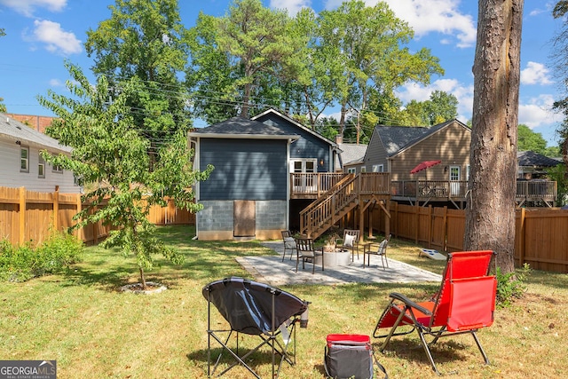 back of house featuring a patio area, a yard, and a wooden deck