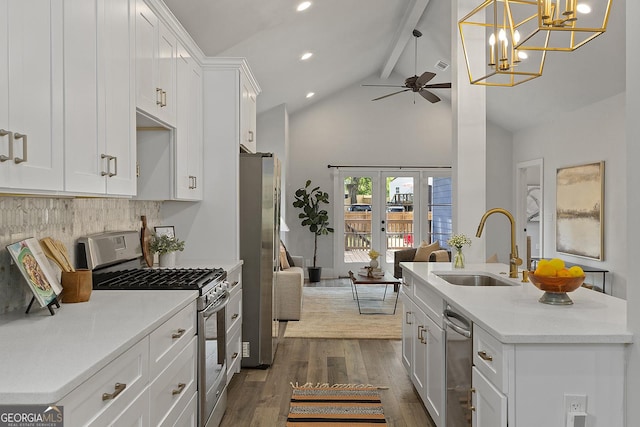 kitchen with white cabinetry, sink, vaulted ceiling with beams, dark hardwood / wood-style flooring, and appliances with stainless steel finishes