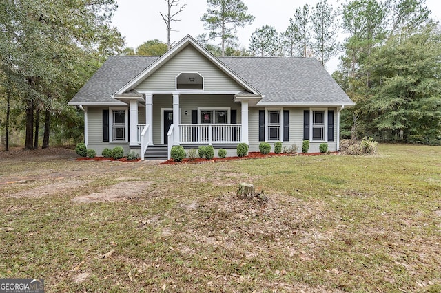 view of front of house with a porch and a front yard