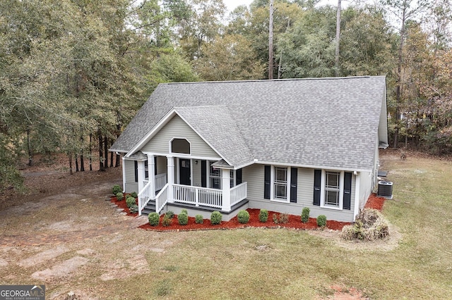 view of front of house with central AC unit, a porch, and a front lawn