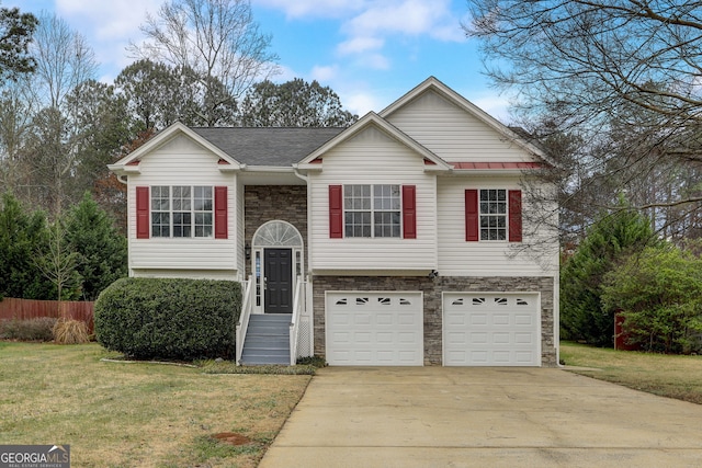 bi-level home with a front yard and a garage