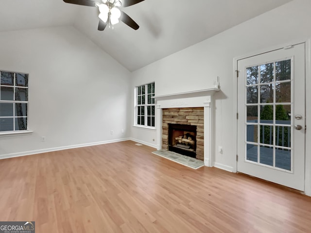 unfurnished living room with a fireplace, ceiling fan, light hardwood / wood-style flooring, and vaulted ceiling